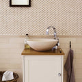 Beige stone vessel sink palio 7 x 30.5 diamond sawn edge honed with curved chrome faucet on wooden countertop