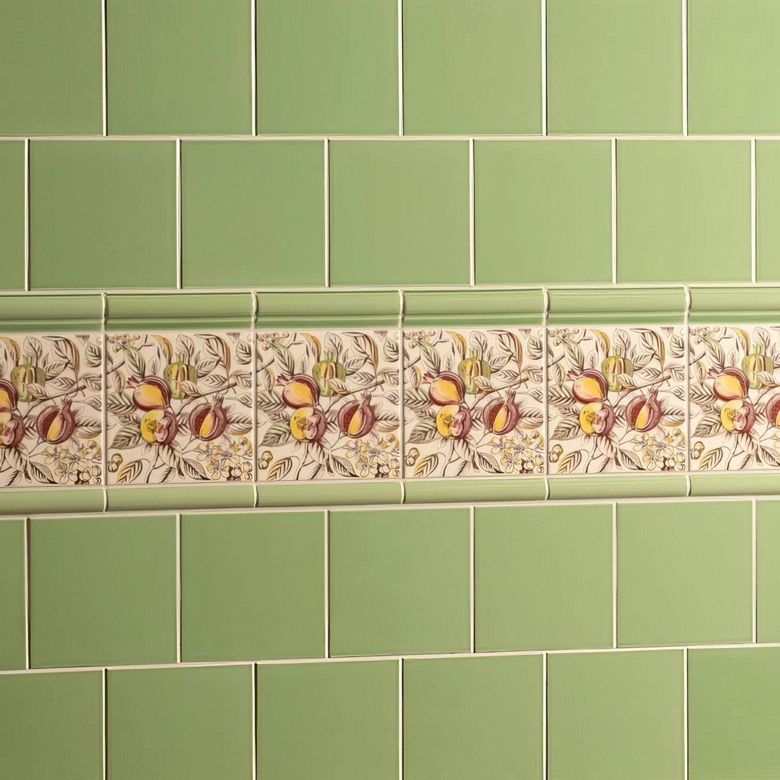 Palm green field tile decorative ceramic strip with pomegranates and foliage in earthy tones on cream background