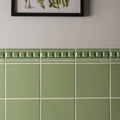 Palm green field tile featuring sage green ceramic tile with decorative raised border pattern for wall and floor use