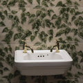 White ceramic wall-mounted palm house ivy single tile sink with two gold-toned faucets