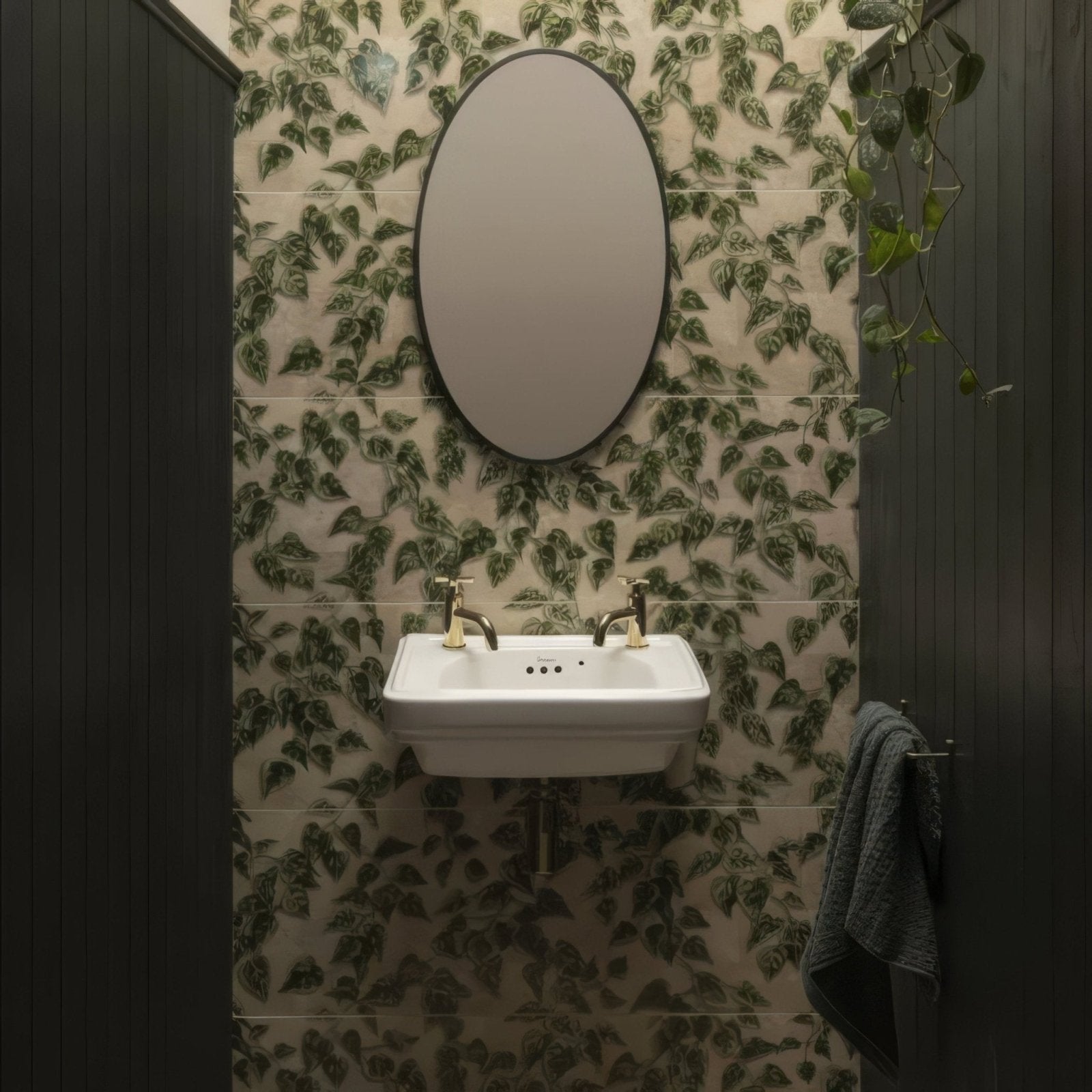 White ceramic wall-mounted sink with gold-toned faucets from palm house ivy single tile collection