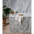 Palm Springs Porcelain Cerulean Fluted white and grey fluted marble-effect tiles with a bathtub and towel