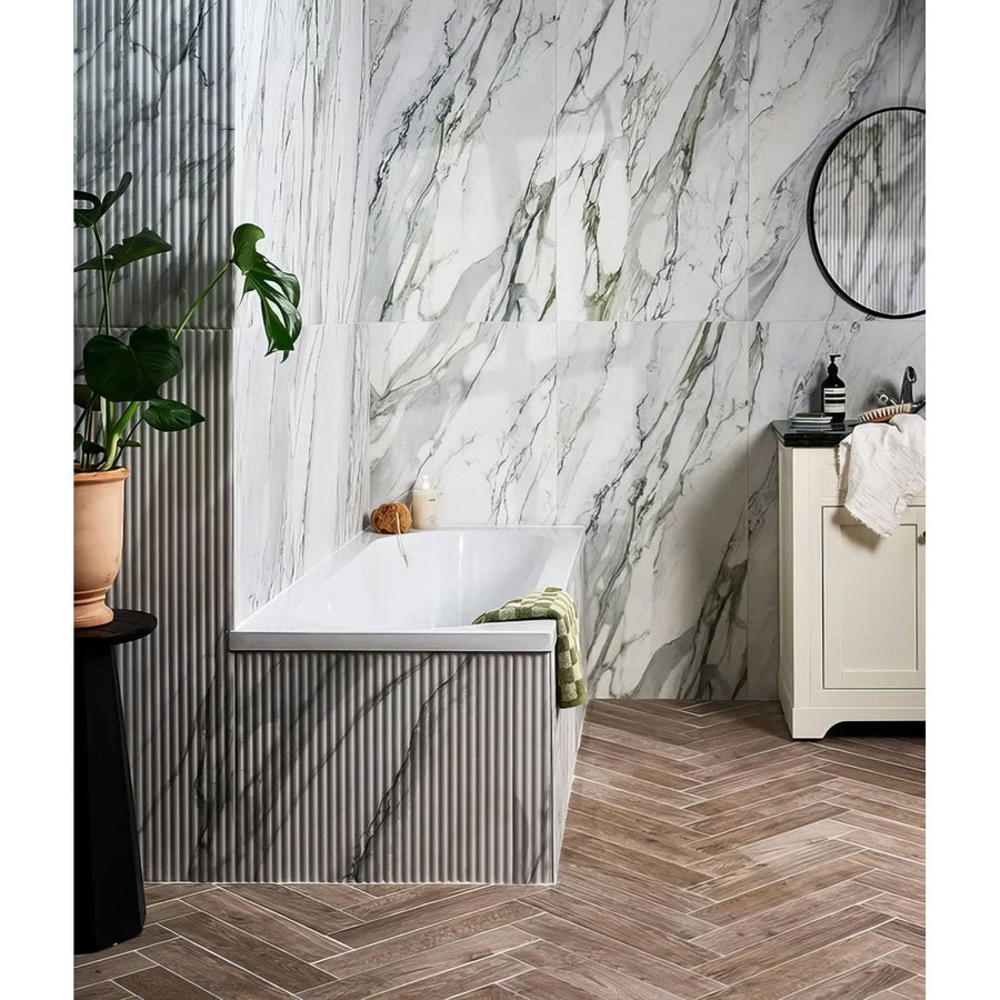 Palm Springs Porcelain Cerulean Fluted white and grey fluted marble-effect tiles with a bathtub and green towel