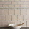 Cream-colored ceramic subway tile backsplash palomino field tile with subtle matte finish and uniform rectangular design