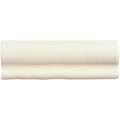 Cream-colored ceramic palomino torus moulding with a smooth glossy finish and subtle wavy baseboard profile