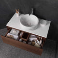 Paradise Tiny Broken Edge Negro Mosaic dark stone mosaic with a white marble vessel sink and wood vanity