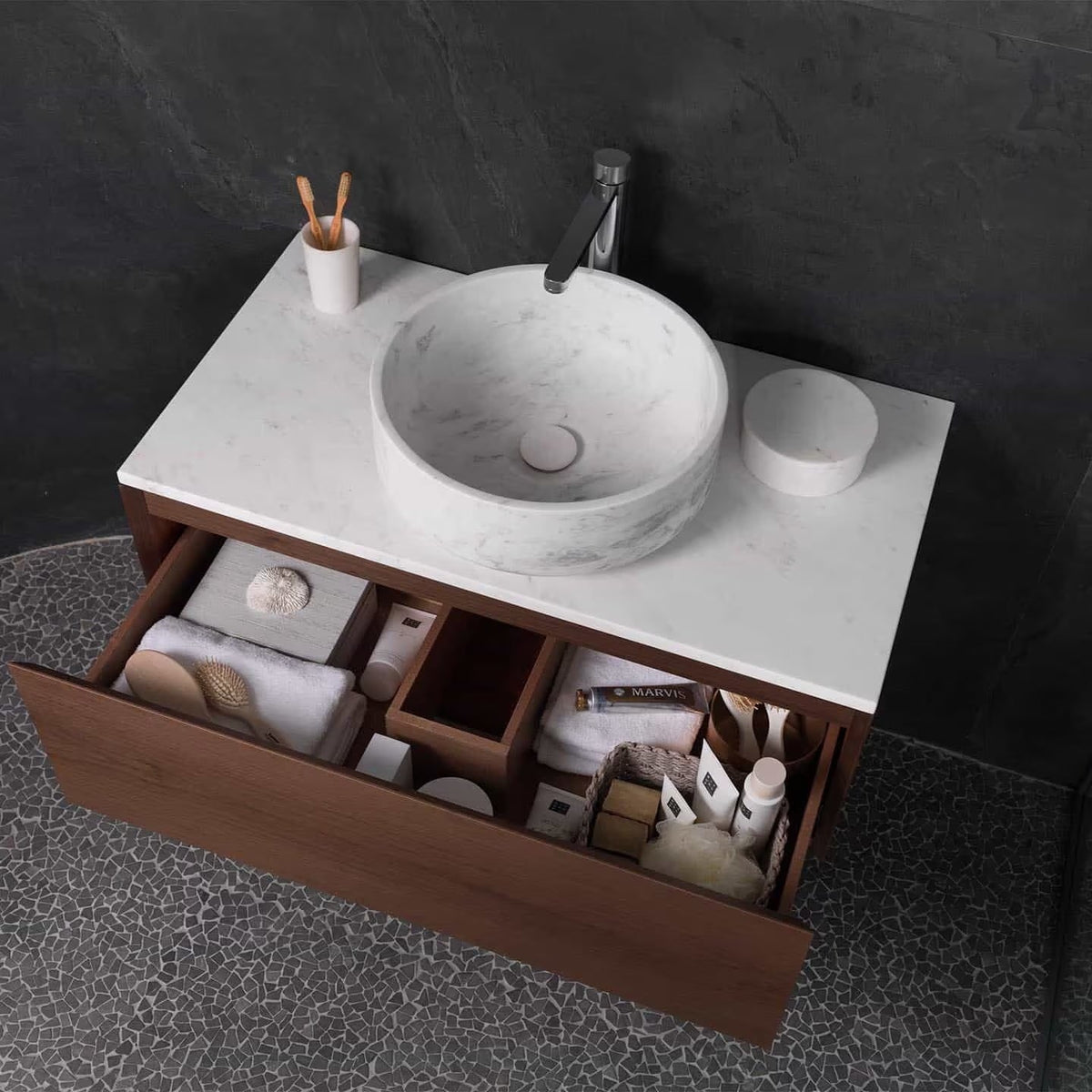 Paradise Tiny Broken Edge Negro Mosaic dark stone mosaic with a white marble vessel sink and wood vanity