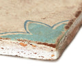 Paris Sandrine rustic beige ceramic tile with faded turquoise floral design and chipped weathered edges