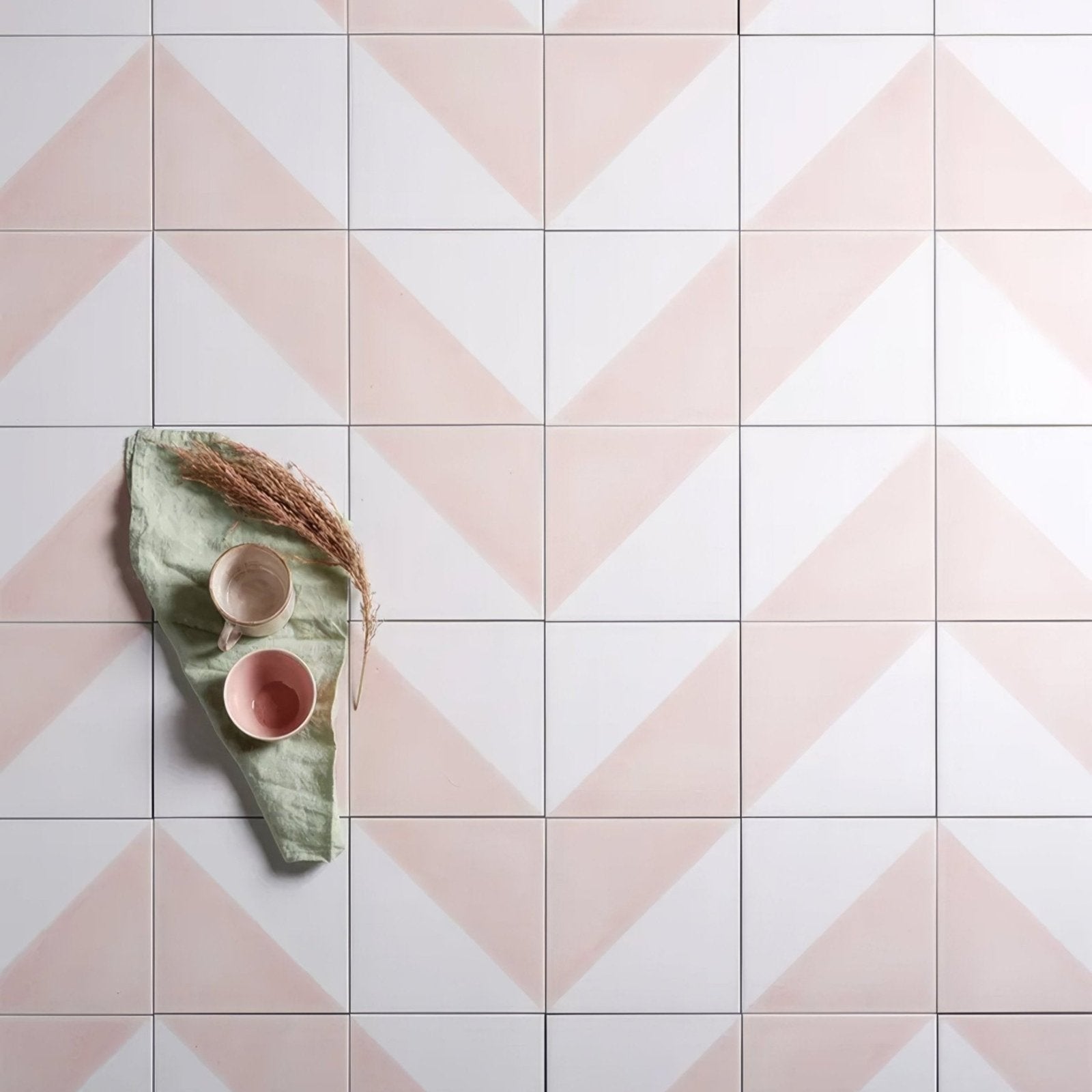 Pastel pink and white geometric patterned porcelain floor tiles for parisian café style interiors