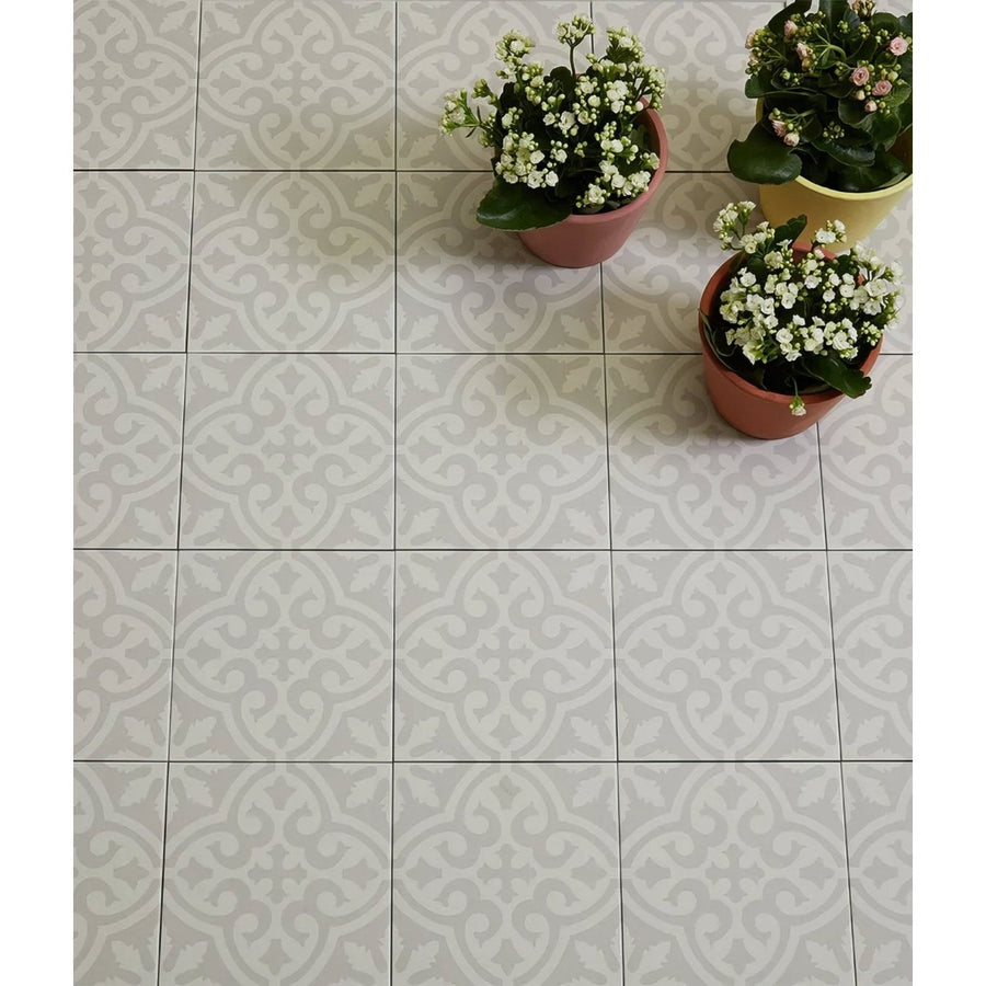 Gray and white ornate patterned Parisian chic porcelain Angelina floor tiles with three terracotta potted plants