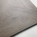 Gray wood-grain vinyl plank flooring in herringbone pattern from parquet khaki collection