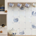 Pastoral Scene Delft River Scene blue and white Delft tile with a ceramic teapot