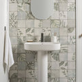White pedestal sink with sleek modern design and matte black faucet featured in patchwork botanical iris 60x30cm