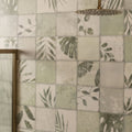 A sleek round brass showerhead with a textured surface and spray holes in the patchwork botanical ivy 60x30cm model