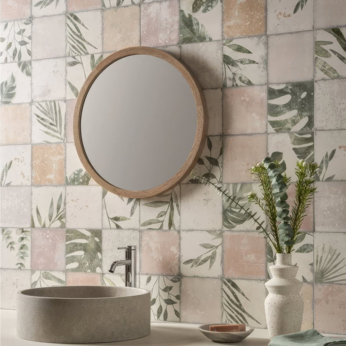 Round wooden-framed mirror mounted on a wall with patchwork botanical rose patterned tiles 60x30cm