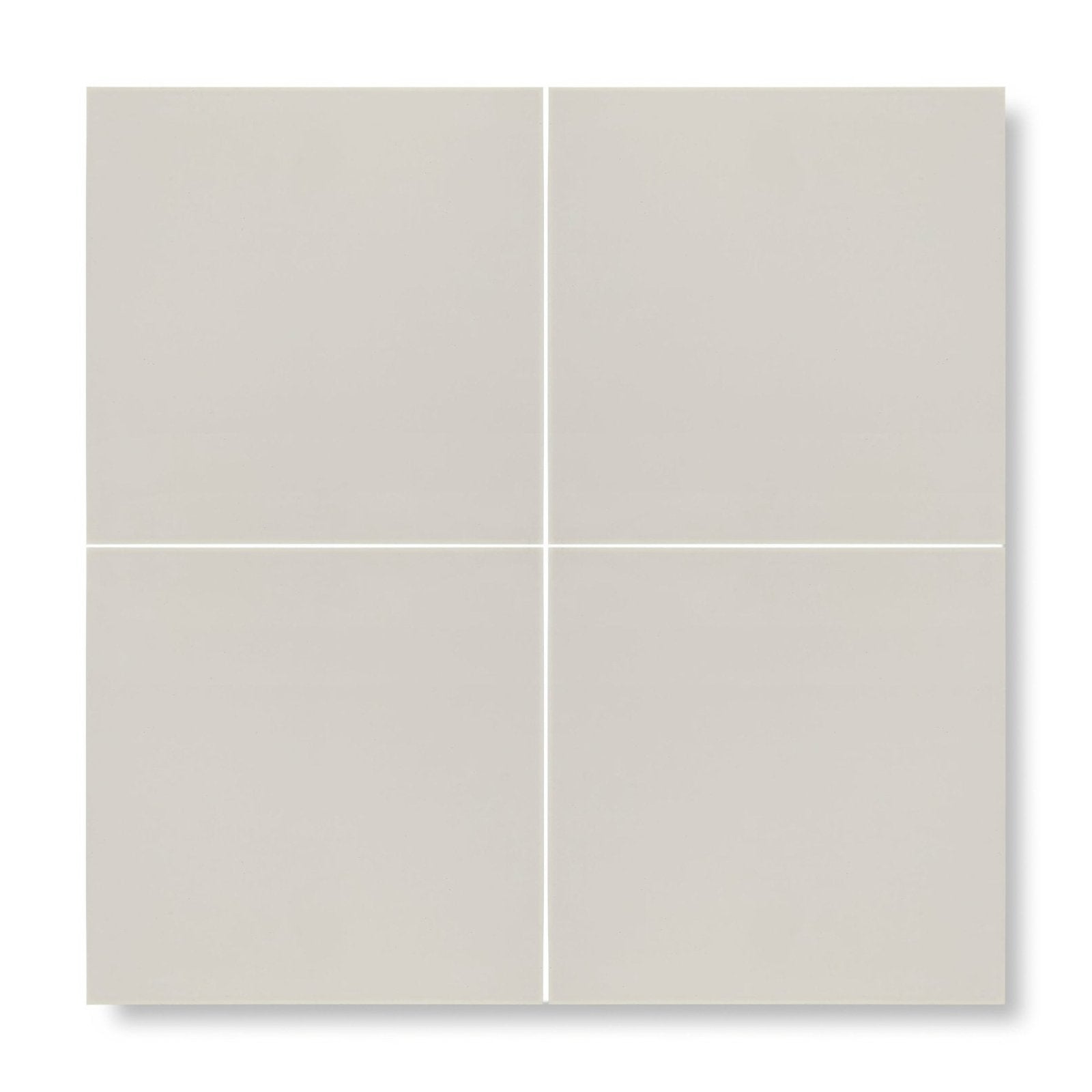 Four square matte-finish beige patisserie blanco porcelain base tiles arranged in a grid pattern