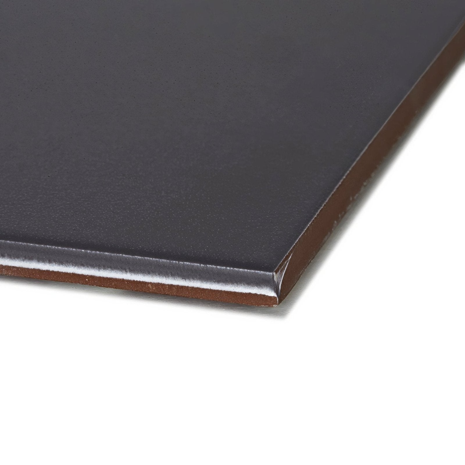 Black rectangular patisserie dark porcelain base tile with smooth matte finish and brown edges