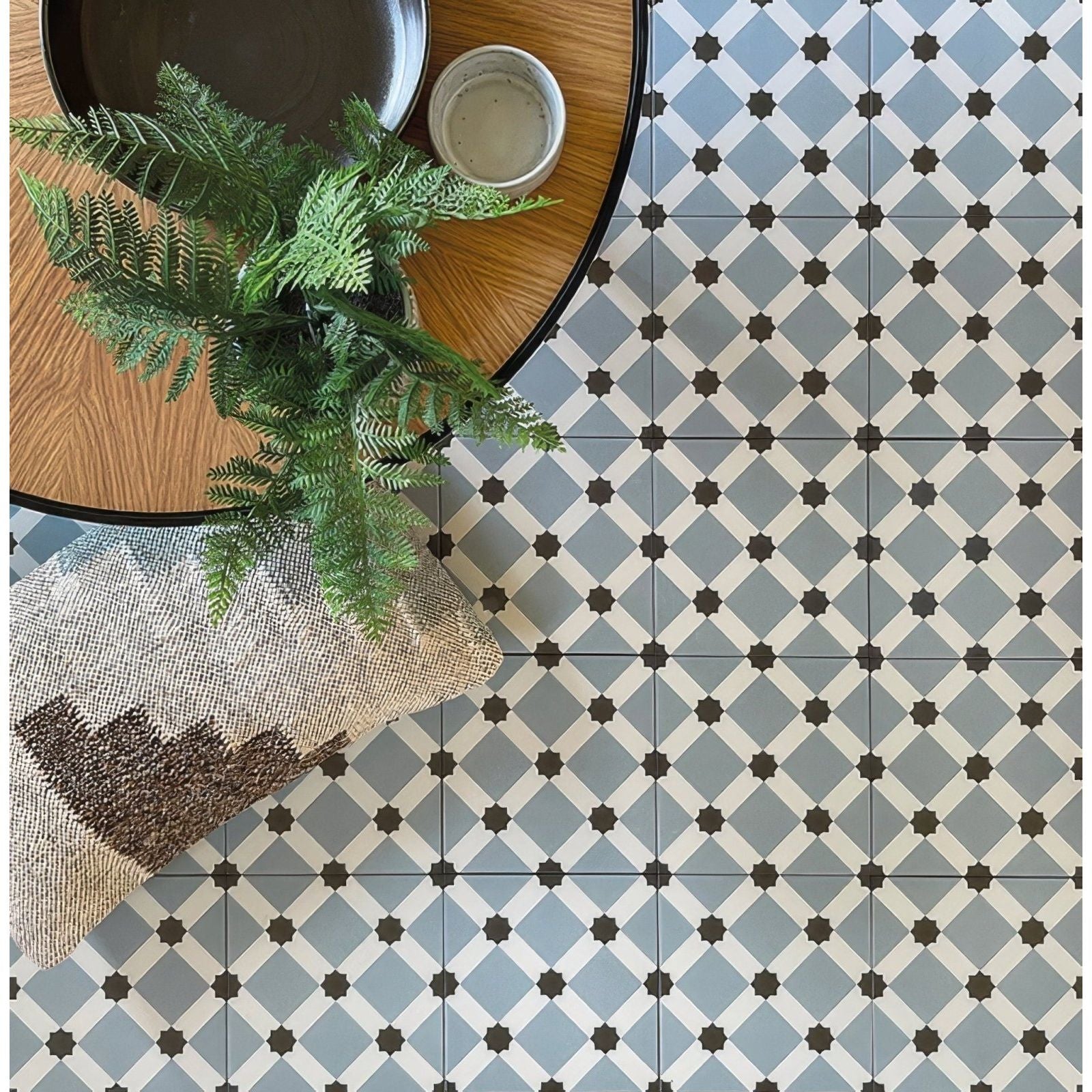 Gray and white geometric patterned patisserie hevin blue tile floor with black star accents for stylish indoor use