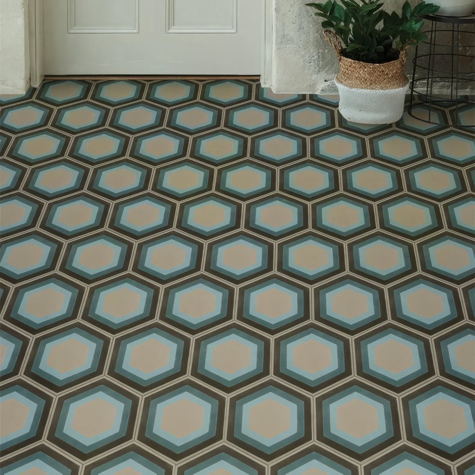 Hexagonal-patterned patisserie porcelain blue floor tiles with beige centers and concentric light blue and dark teal rings