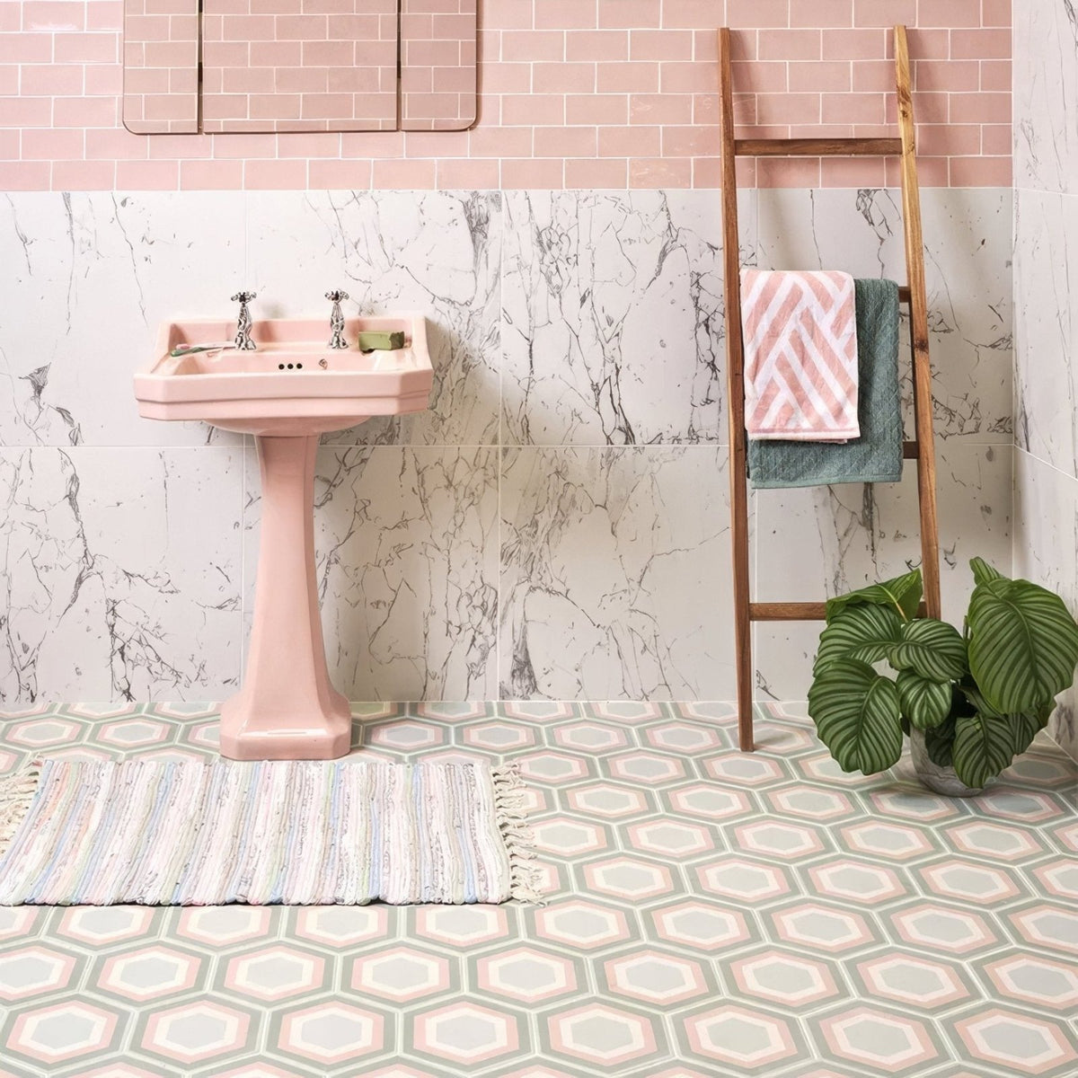 Pink ceramic pedestal sink with chrome faucets in patisserie porcelain rose mint finish for bathroom use