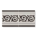 Two rectangular ceramic patisserie sucre border tiles with gray and black ornamental swirling patterns and horizontal stripes