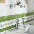 Chrome-finished ornate cross-handle faucets with polished metallic finish on white ceramic sink in pavilion green victoria moulding