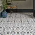 Pavilion Porcelain Marine Blue geometric porcelain mosaic with a blue glass vase of greenery