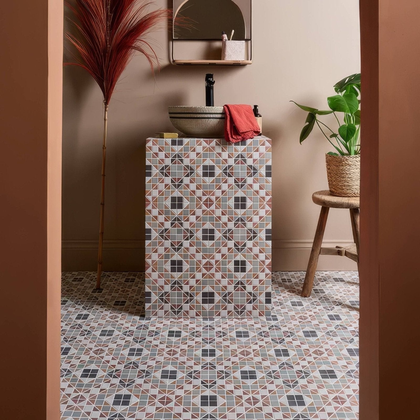 Pavilion Porcelain Russet Red geometric porcelain mosaic on a vanity in muted earth tones