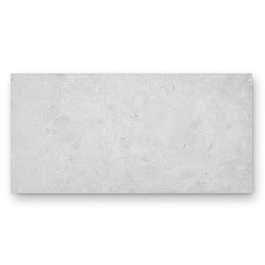A rectangular light gray concrete-effect tile with textured surface pebble beach white 120 x 60cm