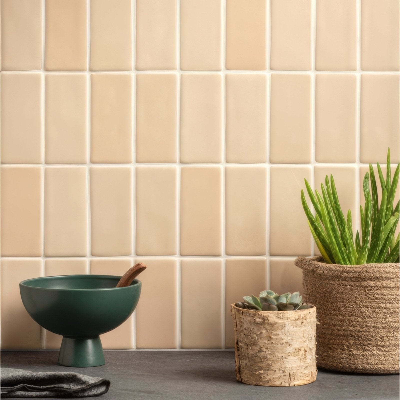 Beige rectangular ceramic pebble half tile with subtle white grout lines for wall and floor applications