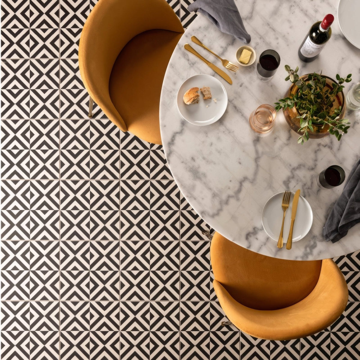 Penshaw black on chalk marble tabletop with gold cutlery and a bottle of wine for elegant dining settings