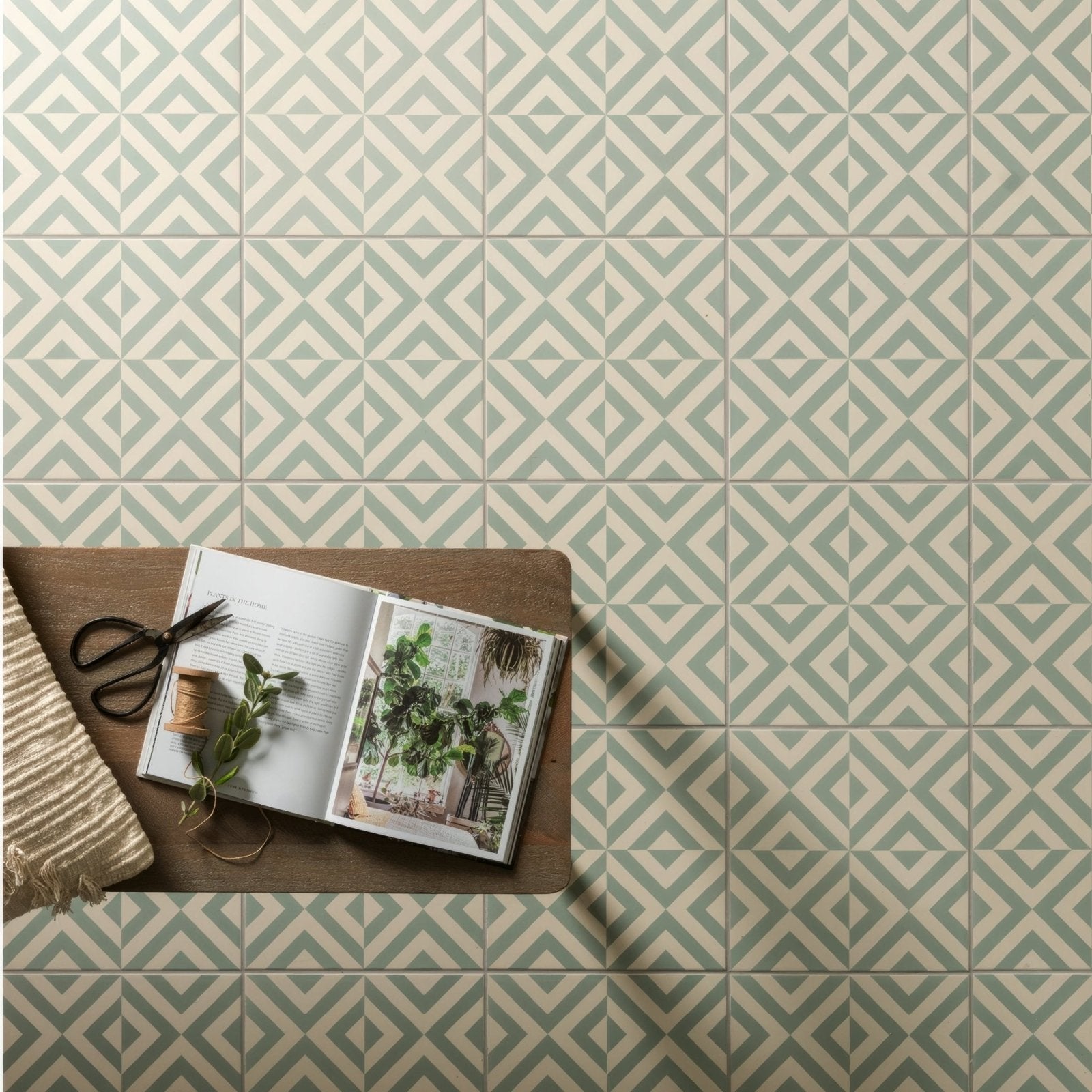 Penshaw teal on chalk geometric patterned floor tiles in muted sage green and off-white for stylish interiors