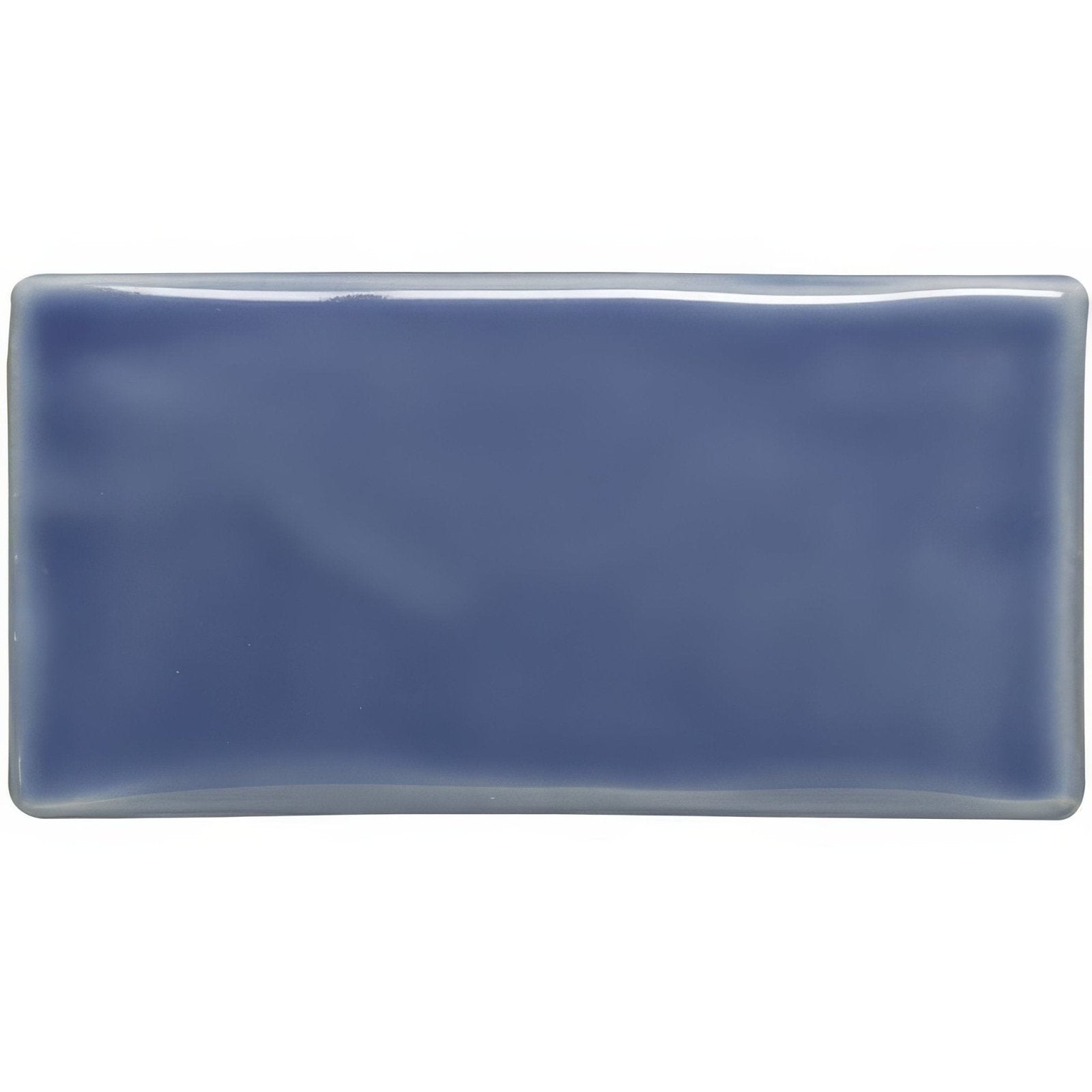 A rectangular glossy blue ceramic tile with softly rounded edges called periwinkle half tile