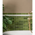 Petite porcelain gloss olive green rectangular subway tiles with glossy finish and white grout in brick pattern