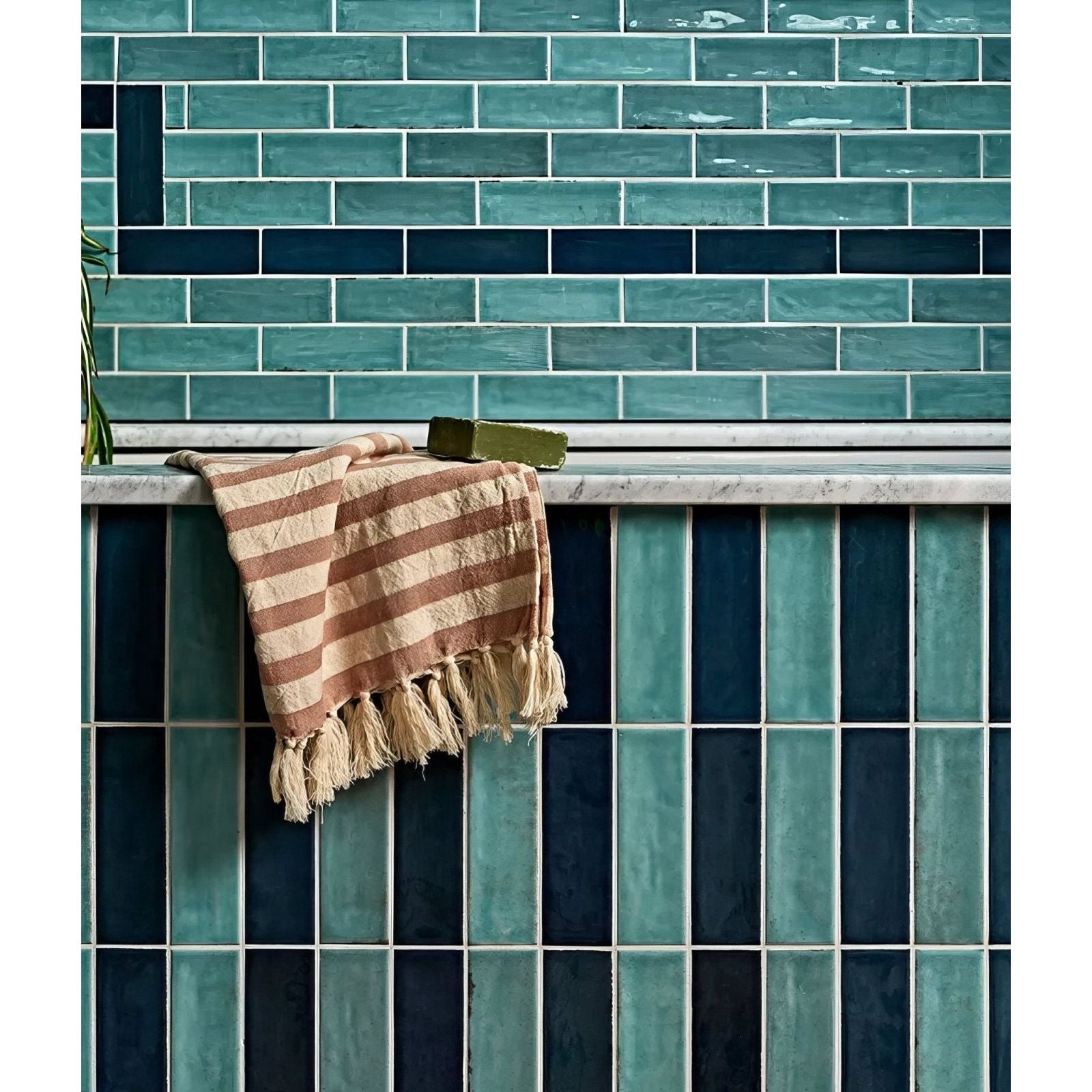 A soft beige and terracotta striped towel with fringed edges on a marble ledge for petite porcelain gloss sky