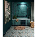 Petite porcelain gloss sky teal-green glossy subway tiles with black grout forming a geometric pattern by bathtub