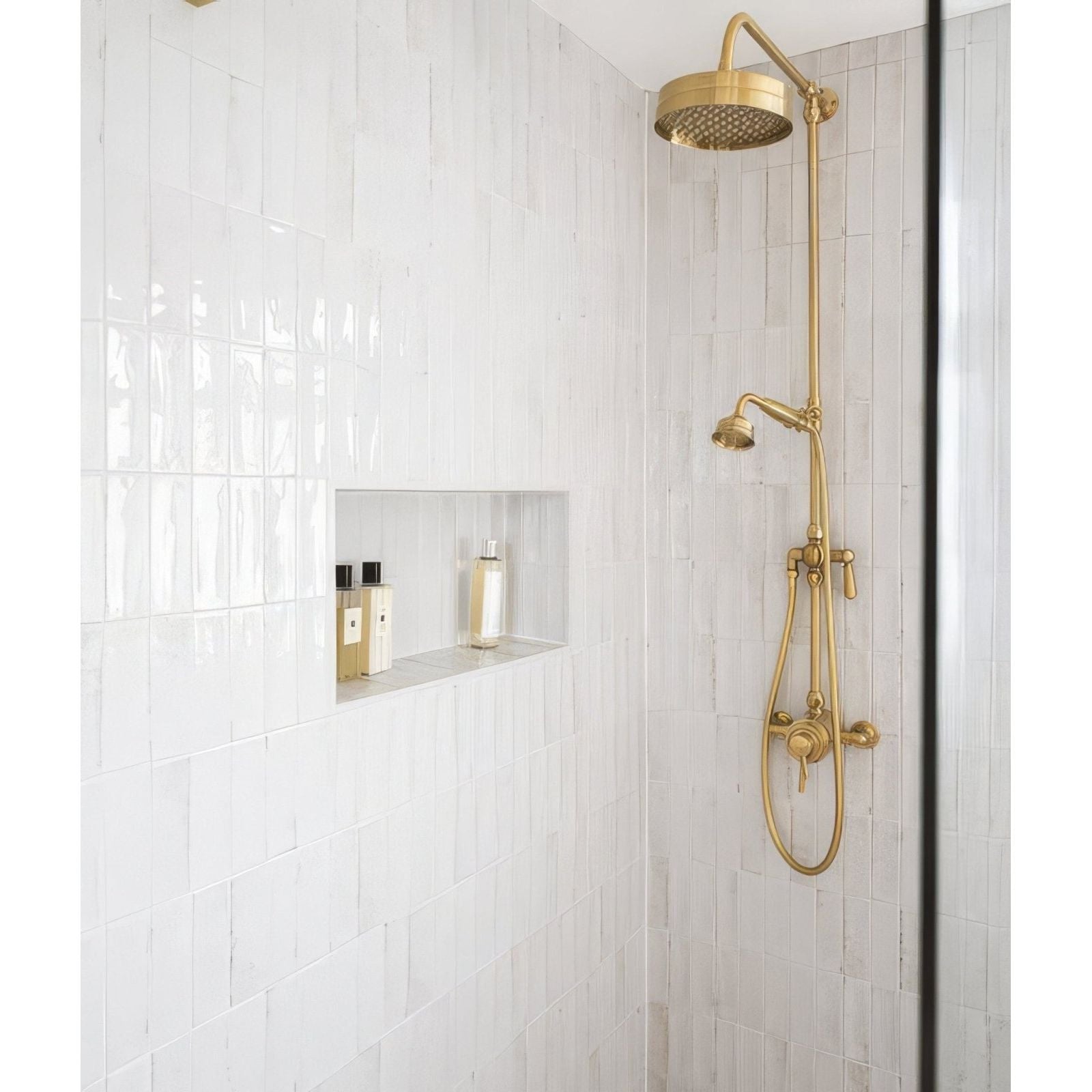 Gold-toned showerhead with sleek modern design and perforated spray face for petite porcelain gloss white bathroom