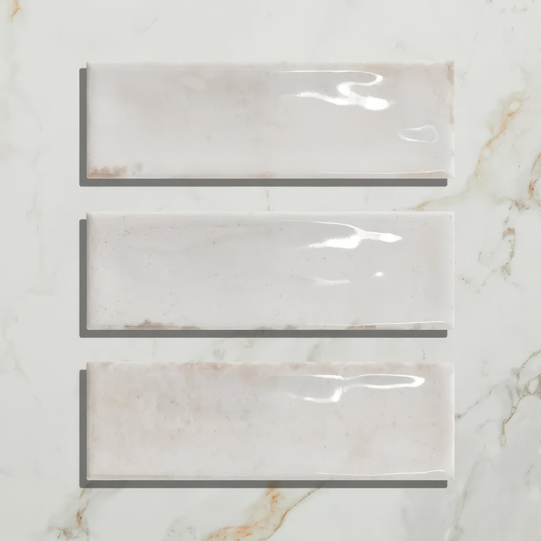 Three rectangular petite porcelain gloss white ceramic tiles with subtle beige veining arranged vertically