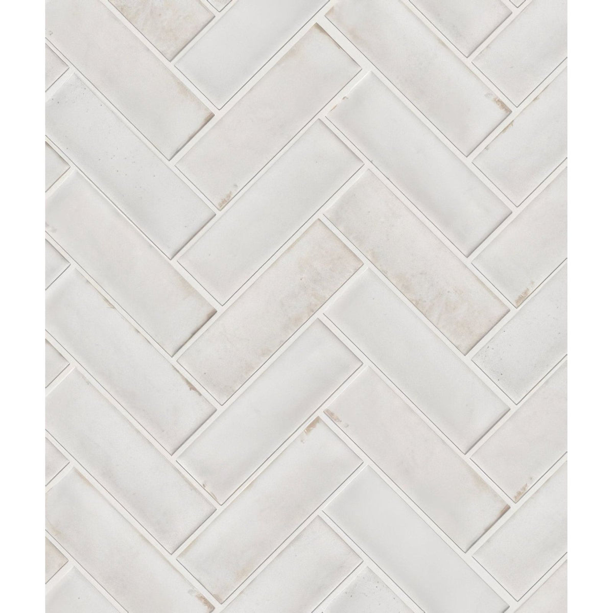 Petite porcelain gloss white marble subway tile with subtle veining arranged in a herringbone layout