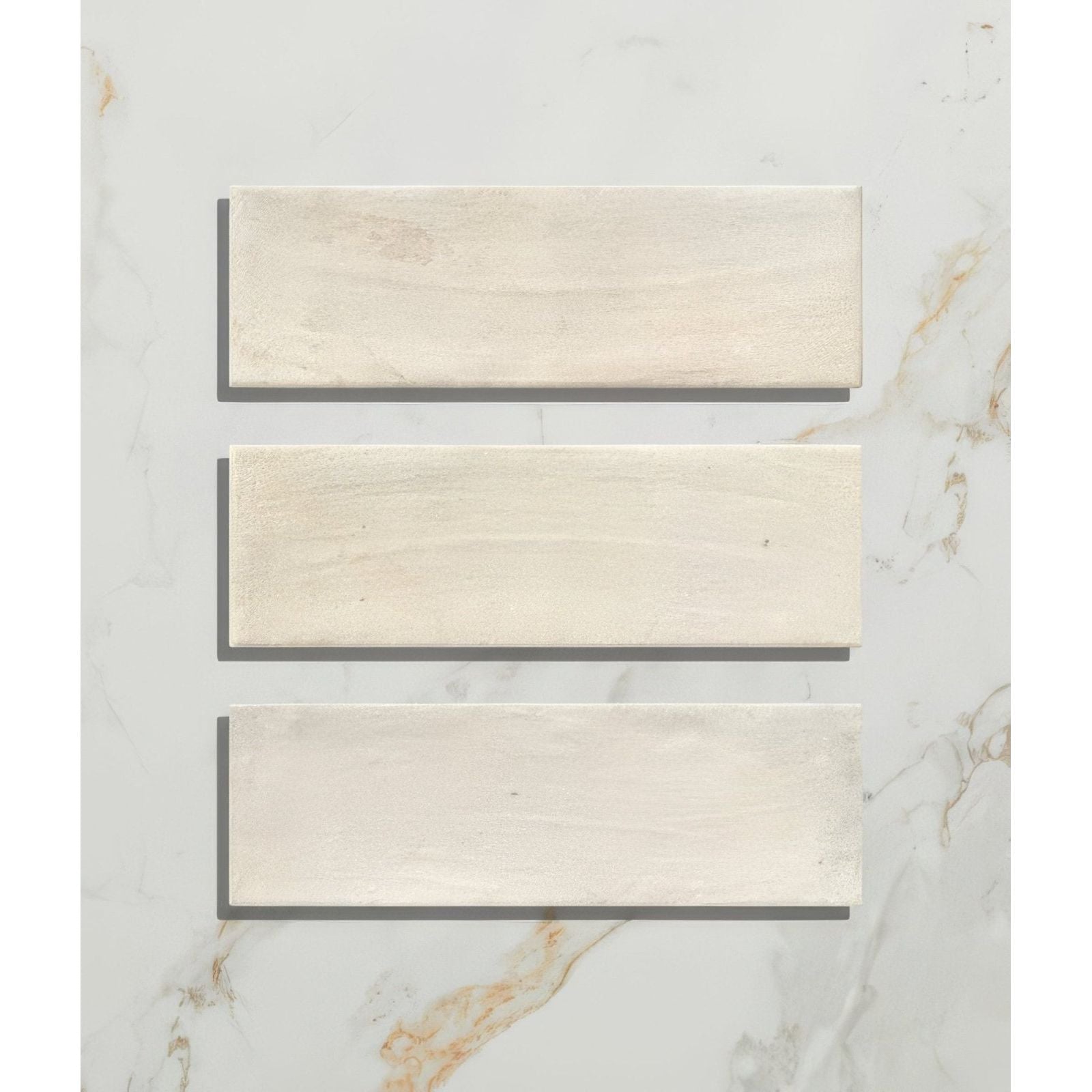 Three off-white petite porcelain matt cotto light tiles with subtle natural stone texture and faint veining