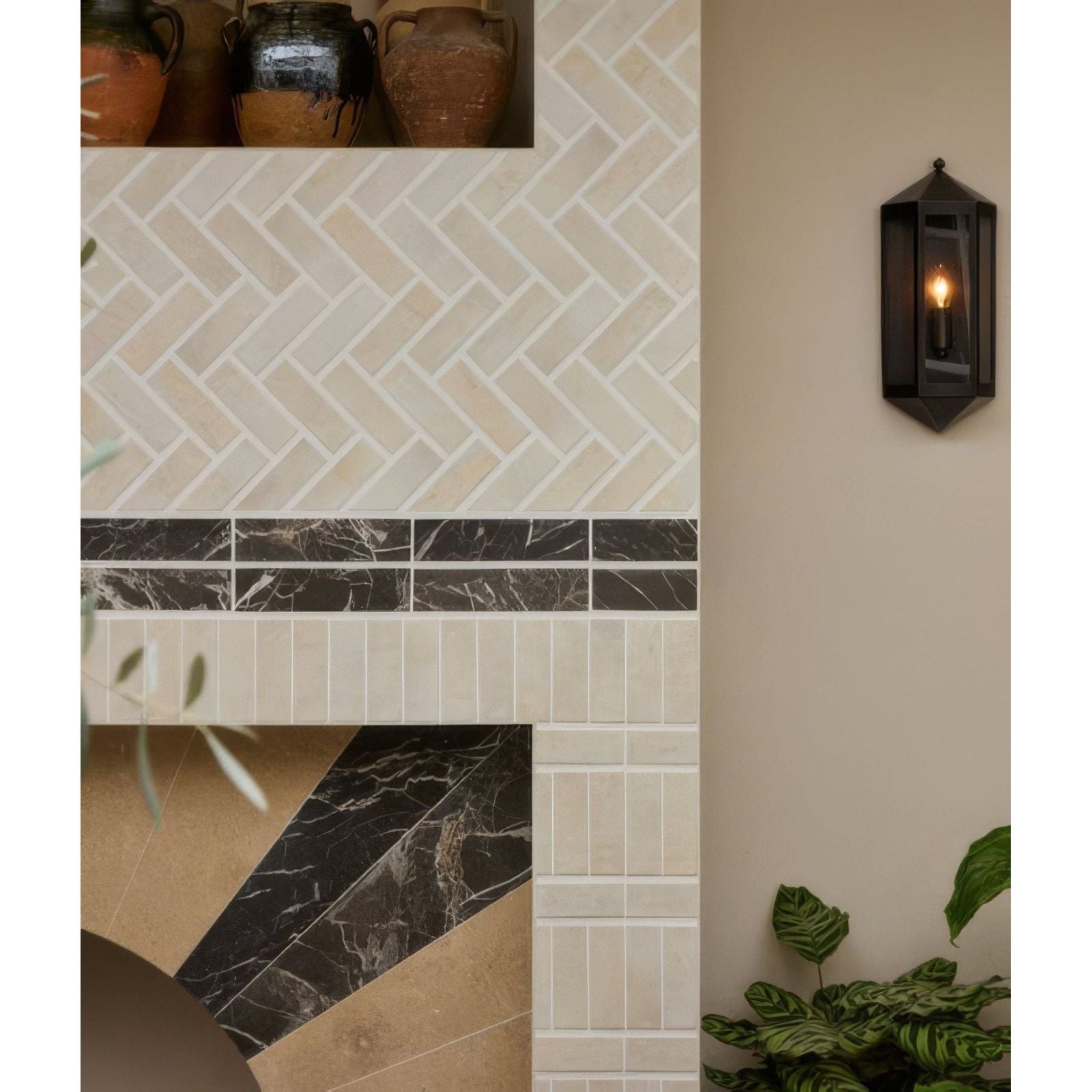 Black hexagonal metal lantern wall sconce with warm glowing bulb petite porcelain matt cotto light