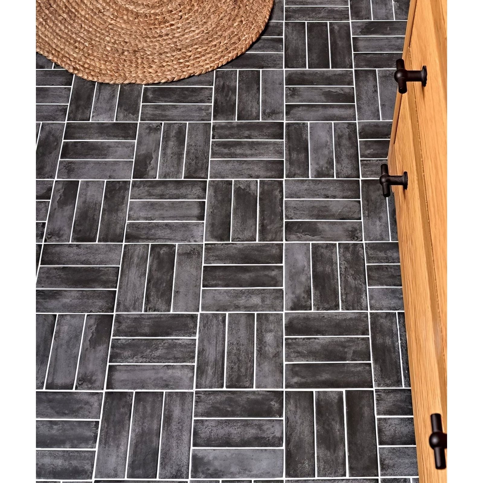 Dark gray petite porcelain matt graphite rectangular tiles with rustic weathered finish in herringbone pattern