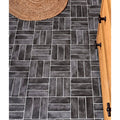 Dark gray petite porcelain matt graphite rectangular tiles with rustic weathered finish in herringbone pattern