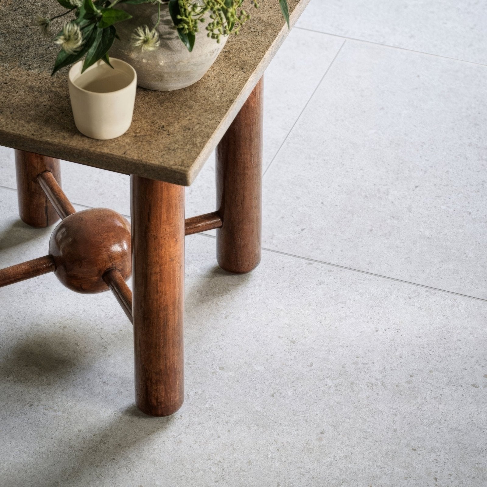 Piazza bone 60 x 120cm rustic wooden table with textured stone top and cylindrical legs joined by a central sphere