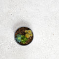 A small round gray ceramic pot with green and yellow spiky cacti in dark soil for piazza white 60 x 120cm
