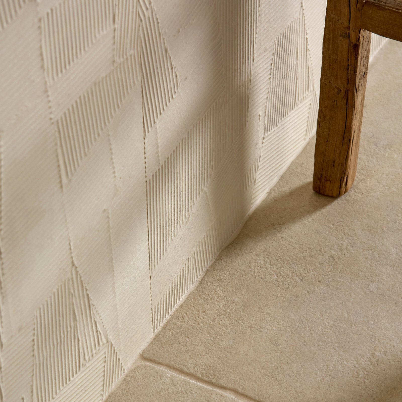 Cream-colored plastercraft calco porcelain sabbia textured wall panel with raised geometric diamond pattern