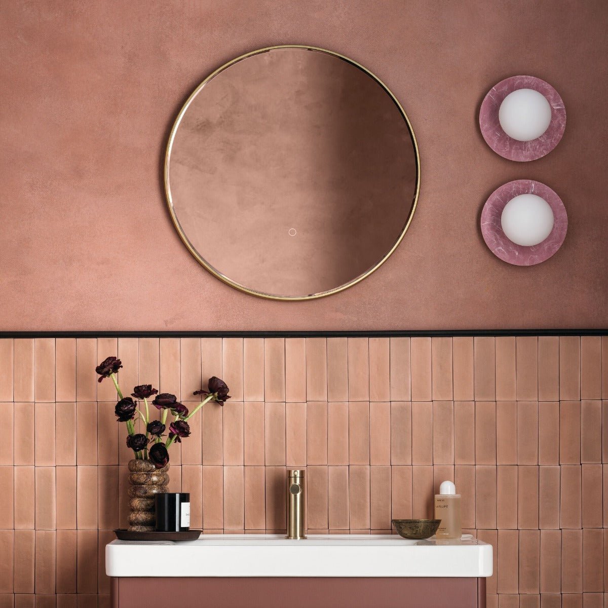 Gold-framed circular mirror with subtle matte finish in pompeiian red perfect for elegant home decor