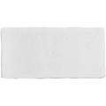 White rectangular mattress topper with a subtle textured surface for use on half tile porcelain floors