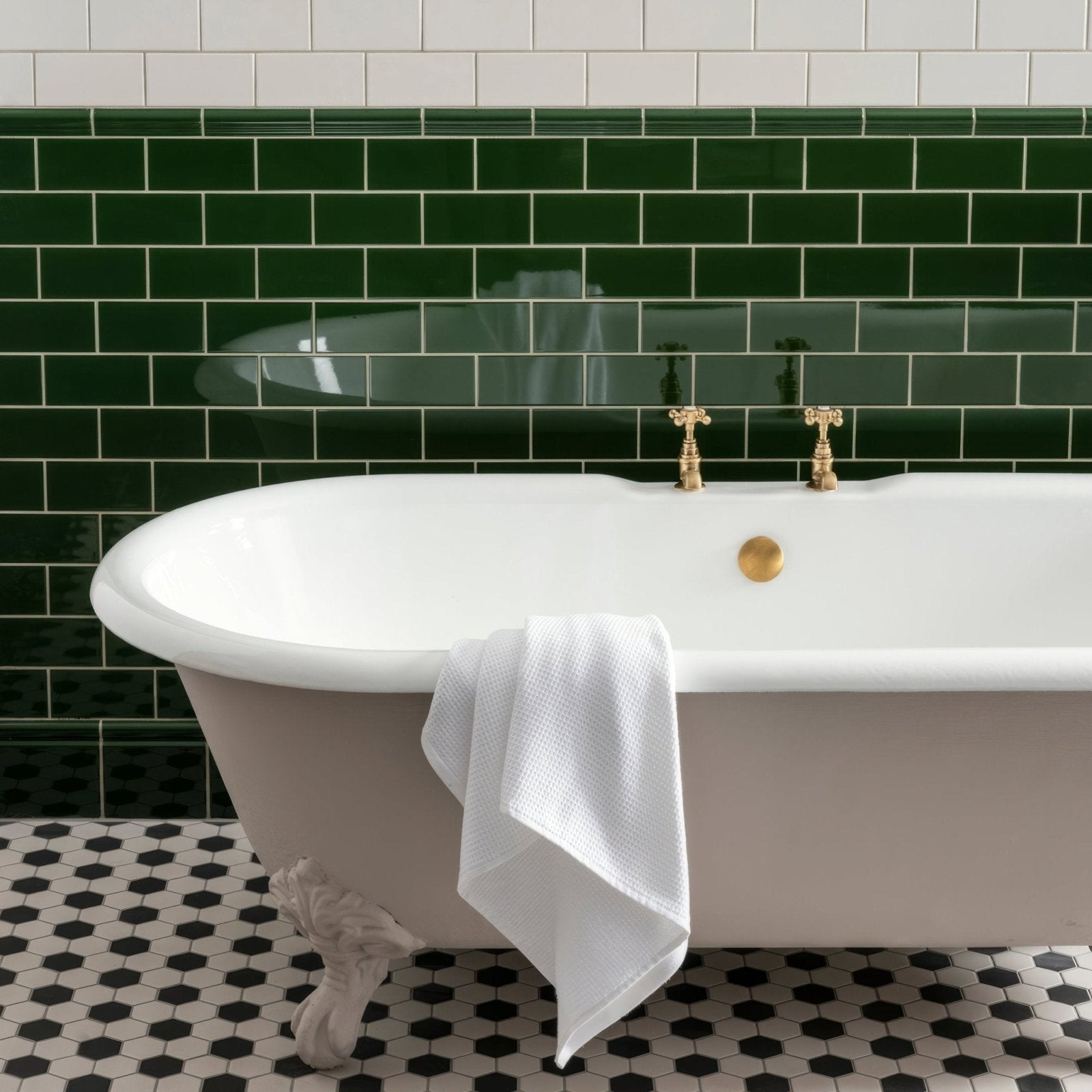 Porcelain Hexagon White & Black white and black hexagonal porcelain mosaic with a clawfoot bathtub
