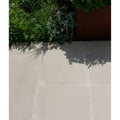 Beige béton chic porcelain paving floor tiles with a smooth glossy finish and textured surface